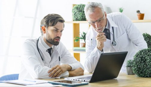 serious-doctors-looking-laptop-screen